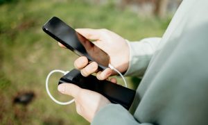 Person holding iPhone and battery pack.jpg